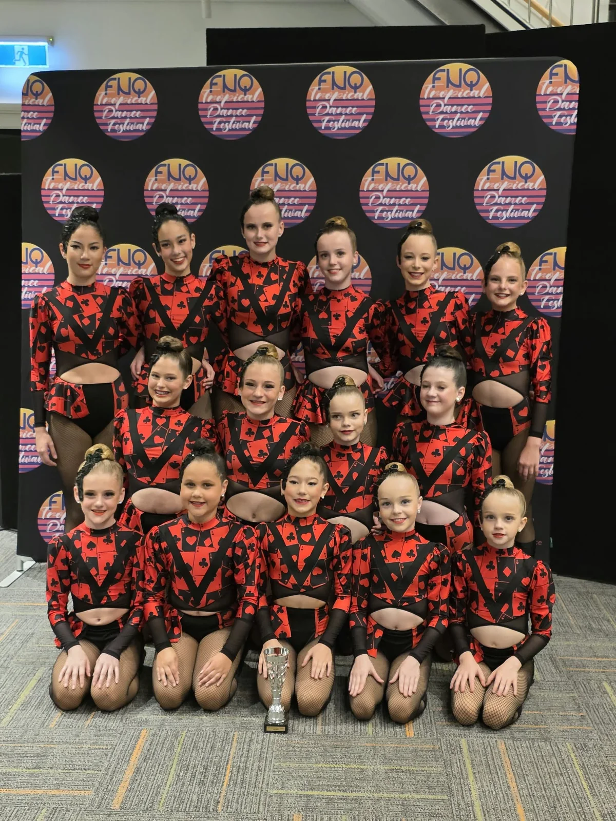 JMDS troupe in red and black playing-card costumes with their trophy